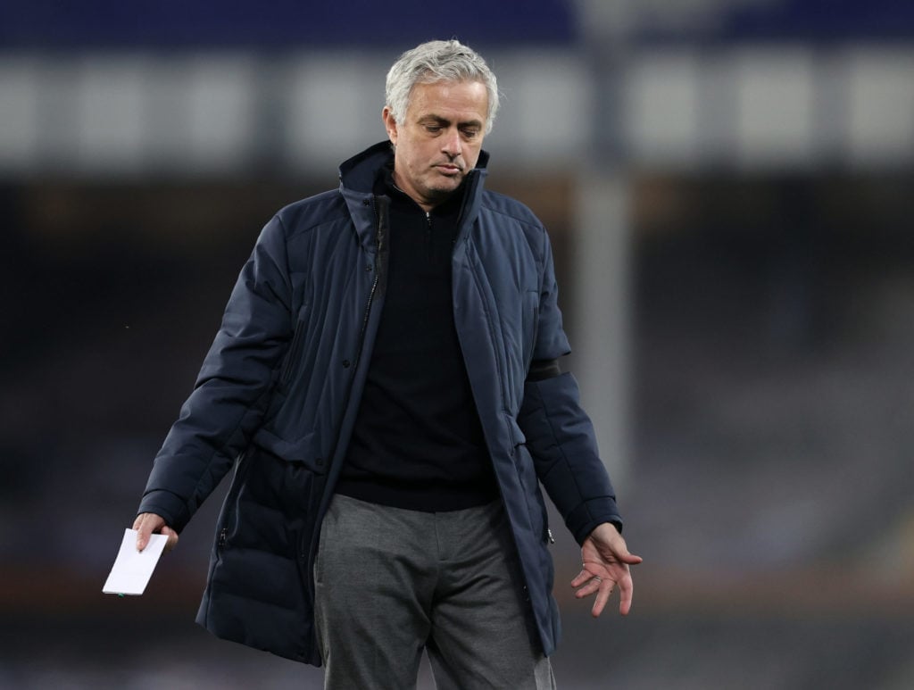 Tottenham manager Jose Mourinho holding notepad