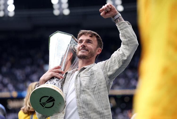 LONDON, ENGLAND - MAY 25: James Maddison of Tottenham Hotspur celebrates with the UEFA Europa League trophy after  the Premier League match between...