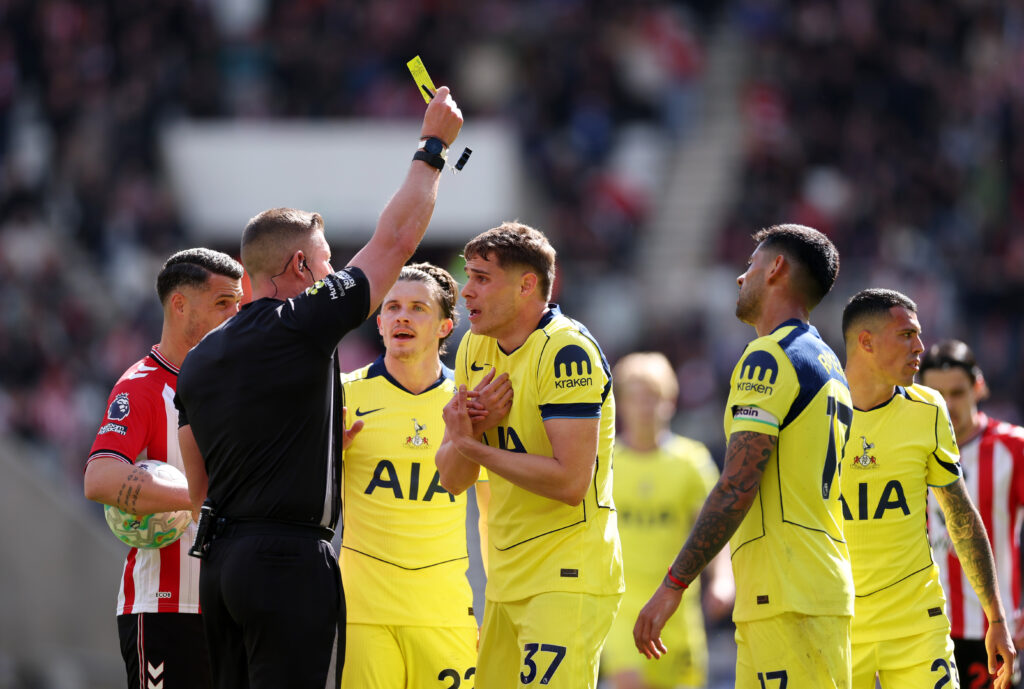 Referee Robert Jones shows a yellow card to Micky van de Ven of Tottenham Hotspur during the Premier League match between Sunderland and Tottenham Hotspur at Stadium of Light.